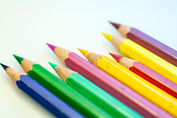 Close up shot of colorful pencils on white background
