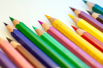 Close up shot of colorful pencils on white background