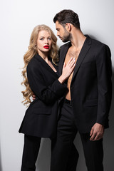 attractive young woman hugging handsome man on white