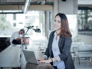 Asian business woman with laptop happy and smile concept success work
