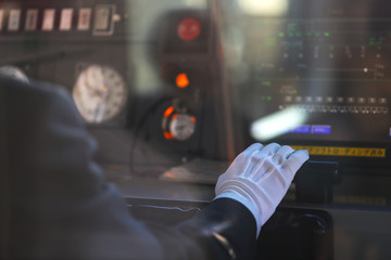 車両室で電車を運転する駅員