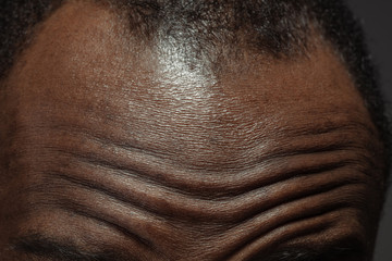 Head, face. Detailed texture of human skin. Close up shot of young african-american male body....