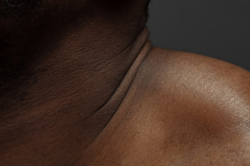 Neck. Detailed texture of human skin. Close up shot of young african-american male body. Skincare, bodycare, healthcare, hygiene and medicine concept. Looks beauty and well-kept. Dermatology.