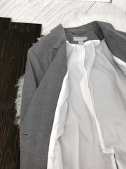White lining of a detailed gray jacket close-up on a wooden background