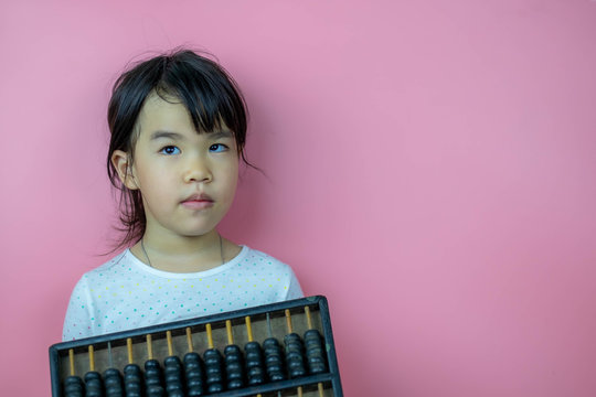 Asian Chinese little girl with abcus chinese calculator