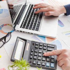 stock market chart and finger pointing on tablet in office
