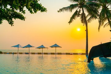 Umbrella and chair around swimming pool with sea ocean view