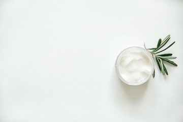 Herbal dermatology, hygienic cream skincare product in glass jar on white background