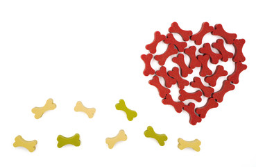 Dog treats in dog bone shape arrange in heart shape isolated on white background , Valentine day and love dog concept