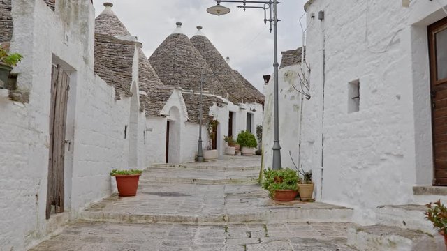 Walking streets of trulli town Alberobello, Italy