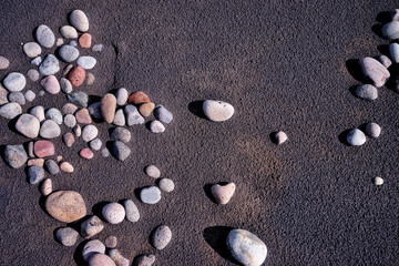 Fototapeta na wymiar Black sand and pebble. Textured background.