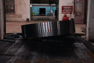 Round billet for the manufacture of parts at the factory. Steel billets for the production of fittings. Metalworking technology at the factory. Expect Further Processing
