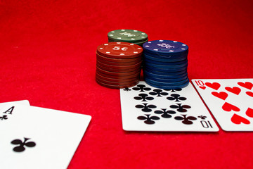 Playing cards aces and tens on a red background