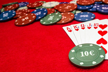 Playing cards poker chips on a red background