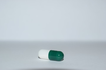 pills and syringe on white background