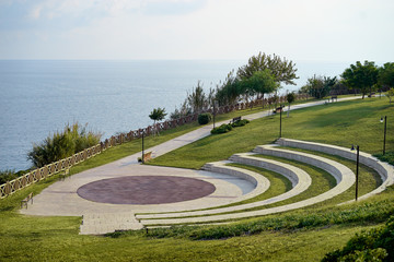 Lara city park with blue sky and sea. Modern amphitheatre. Broadwalk in Antalya, Turkey.