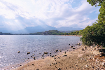 Landscape with Meditterranean sea beach and mountains.