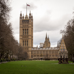Fototapeta na wymiar Palace of Westminster, London. A view from Victoria Tower Gardens looking towards The Houses of Parliament, the seat of UK politics and government.