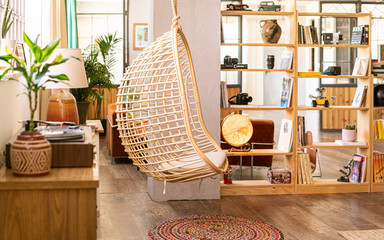Hanging armchair in a corner of the living room. Interior design / decoration. Open space in a...