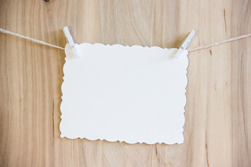 white sheet on clothespins hang on thread