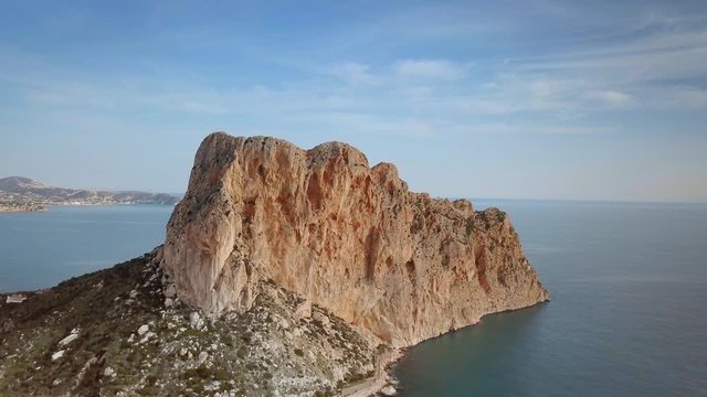 Aerial view big rock near Parque natural del Penon de Ifach in Calpe, symbol of Calpe town, 4k footage. Province of Alicante, Costa Blanca, Spain