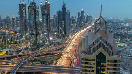 View on modern skyscrapers and busy evening highways day to night timelapse in luxury Dubai city, Dubai, United Arab Emirates