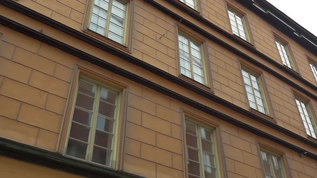 Apartment building streets in old northern european city. Scandinavian windows. Facades of colorful houses in the streets of Sweden. Traveling concept. Slow motion. Steadicam shot