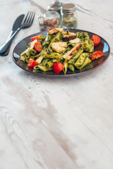 Penne cooked cereal specialty with cooked chicken fillets and a sauce made with olive oil