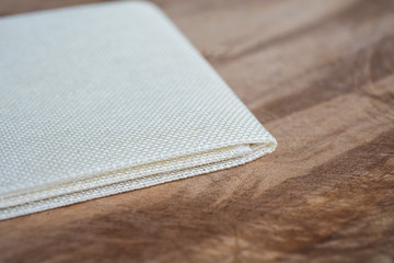 Vintage fabric on wood texture.