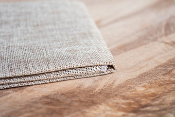 Vintage fabric on wood texture.