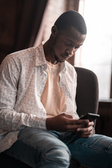 Smart Black Freelancer Is Chatting In His Smartphone