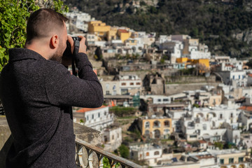 Man taking picture of Positano town, Italy