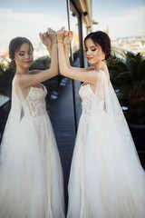 Naklejka premium Tender bride near the mirrors on the roof