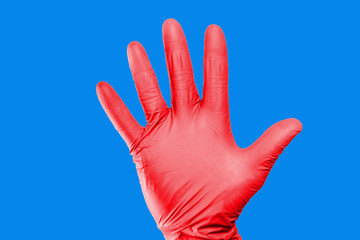 Hand stop gesture. Red latex glove isolated. Five fingers palm open hand. Higiene virus protection background.
