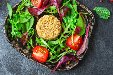Healthy quinoa salad leaves mix (mix micro greens, cucumber, tomato, other ingredients). food...