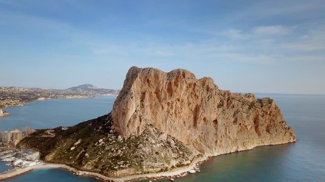 Aerial view big rock near Parque natural del Penon de Ifach in Calpe, symbol of Calpe town, 4k footage. Province of Alicante, Costa Blanca, Spain