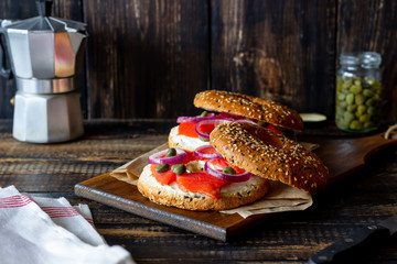 Bagels with salmon, white cream cheese and capers on a wooden background. Recipes. Healthy eating.
