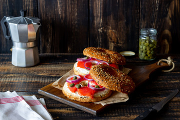 Bagels with salmon, white cream cheese and capers on a wooden background. Recipes. Healthy eating.