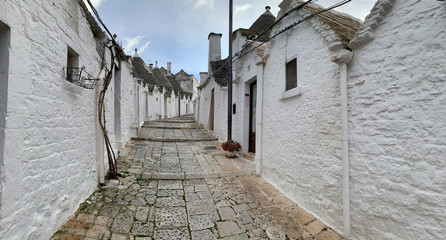 Walking streets of trulli town Alberobello, Italy