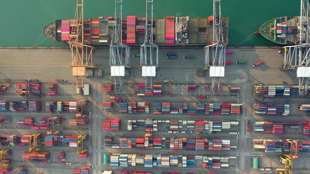 Aerial view. Container ship in pier with crane bridge carries out export and import business in the open sea. Logistics and transportation	