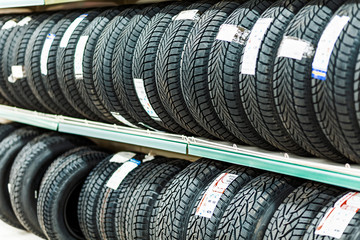 Car new tires stacked in rows in the store