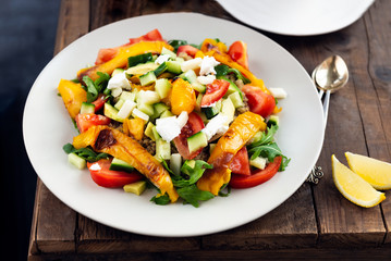 Detox healthy dinner from Quinoa Salad with vegetables such as cucumbers, cherry tomatoes, pepper and goat cheese. Vegetarian food.