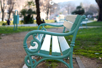 Retro mint green bench in a park. Selective focus.