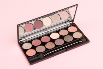 set of pastel eyeshadows isolated on rose background