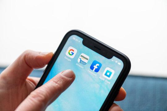 Paris, France - February, 20, 2020 : Mobile phone displaying the Gafa site in a woman's hand  : GAFA apps and icons on an iPhone. 