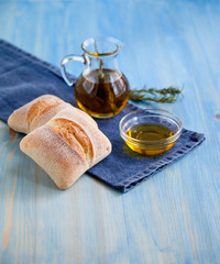 Ciabatta bread with herbs and olive oil on wooden background ready to eat snack Mediterranean style