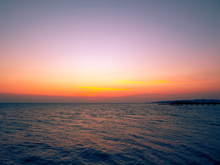 Beautiful dramatic sunset over the ocean. Sunrise on sea skyline. Waves over beach coast for wallpaper