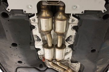 Catalytic converter. Exhaust system of a modern car bottom view.