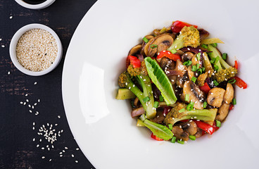 Stir fry vegetables with mushrooms, paprika, red onions and broccoli. Healthy food. Asian cuisine....