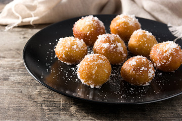 Carnival fritters or buñuelos de viento for holy week on wooden table